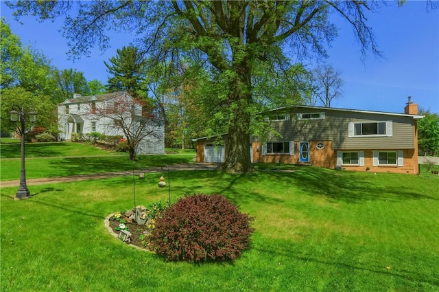 view of front of home with a chimney and a front yard