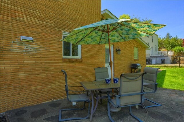 view of patio / terrace featuring outdoor dining area and fence