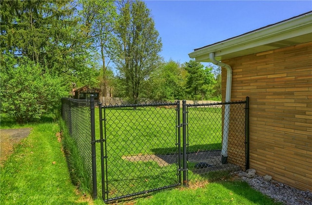 view of gate featuring a lawn and fence