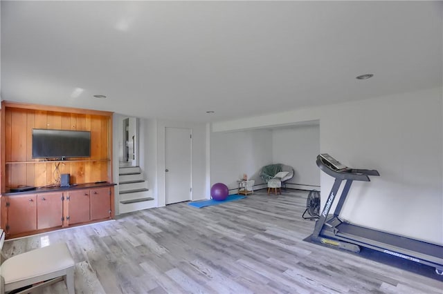 exercise room with recessed lighting and light wood-type flooring