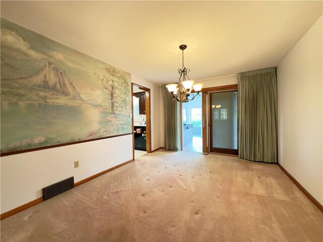 unfurnished dining area with a chandelier, baseboards, visible vents, and carpet
