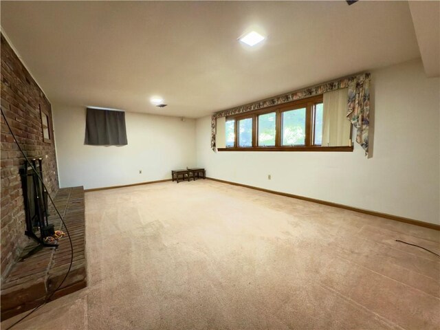 unfurnished living room with baseboards, carpet, and a brick fireplace