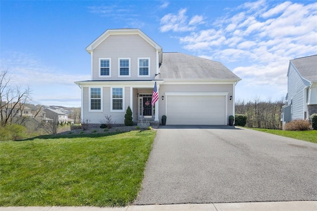 traditional-style home with a garage, a front lawn, and aphalt driveway