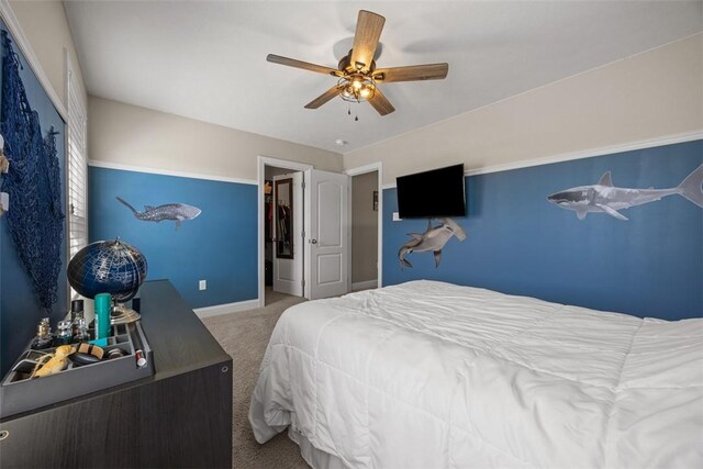 carpeted bedroom with baseboards and a ceiling fan