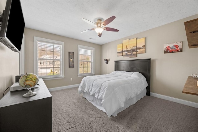 bedroom featuring baseboards, ceiling fan, light carpet, and a textured ceiling