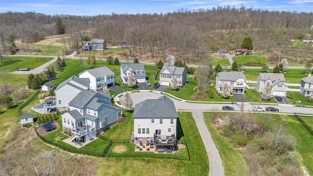 birds eye view of property with a residential view and a wooded view