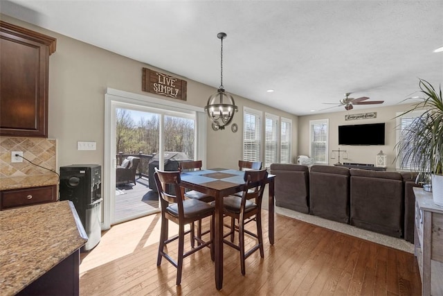 dining room featuring recessed lighting, light wood-style flooring, and ceiling fan with notable chandelier