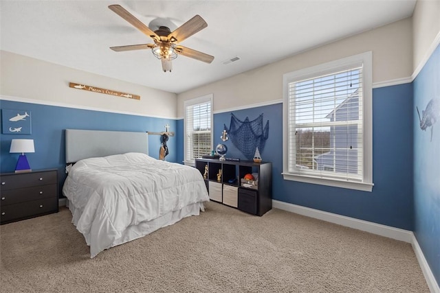 bedroom with carpet floors, baseboards, ceiling fan, and visible vents
