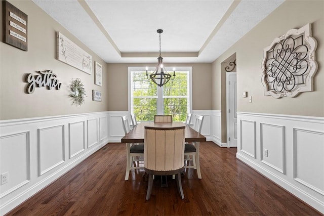 118 General Ct, Lehigh Twp, PA 16063 - dining room with a chandelier, a tray ceiling, a decorative wall, dark wood finished floors, and wainscoting