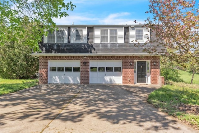 view of front of house with brick siding, an attached garage, and concrete driveway