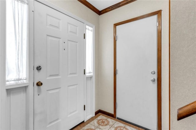 foyer featuring light tile patterned floors, baseboards, and ornamental molding
