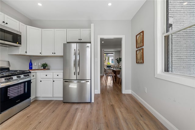 7314 Monticello St, Homewood-Brushton, PA 15208 - kitchen with recessed lighting, light wood finished floors, appliances with stainless steel finishes, and white cabinetry