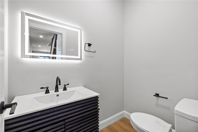 7314 Monticello St, Homewood-Brushton, PA 15208 - bathroom with baseboards, vanity, toilet, and wood finished floors