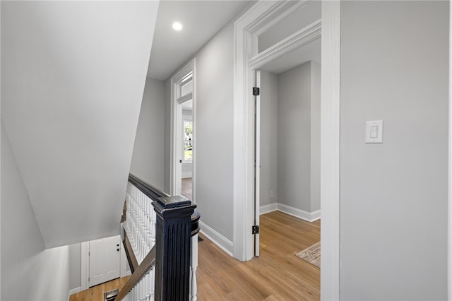 7314 Monticello St, Homewood-Brushton, PA 15208 - corridor featuring baseboards, recessed lighting, light wood finished floors, and an upstairs landing