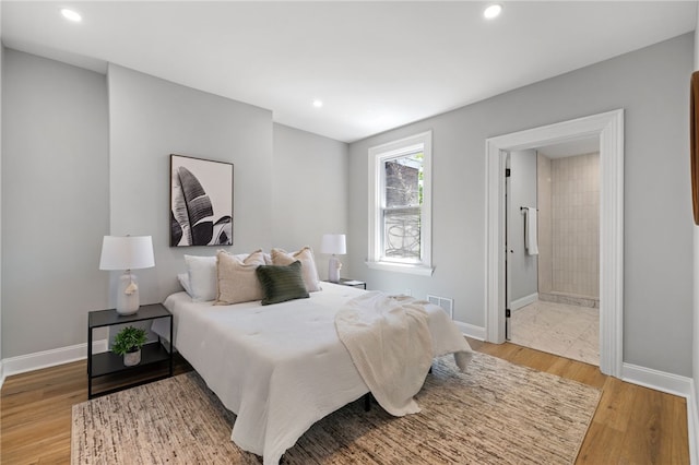 7314 Monticello St, Homewood-Brushton, PA 15208 - bedroom featuring recessed lighting, baseboards, ensuite bathroom, and light wood-style floors