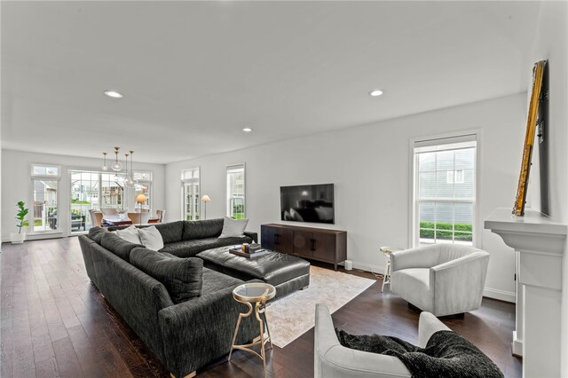 living area with recessed lighting, a wealth of natural light, and dark wood-style floors
