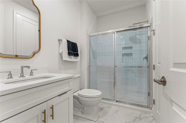 bathroom with vanity, a stall shower, toilet, and marble finish floor