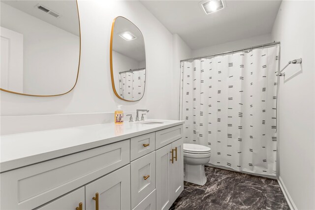 full bath featuring visible vents, vanity, marble finish floor, toilet, and baseboards