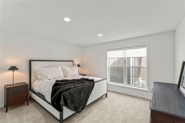 bedroom with baseboards, light carpet, and recessed lighting