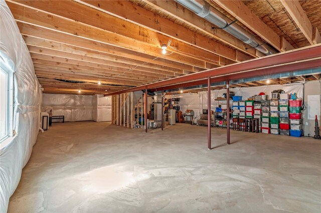 unfinished basement with heating unit and water heater