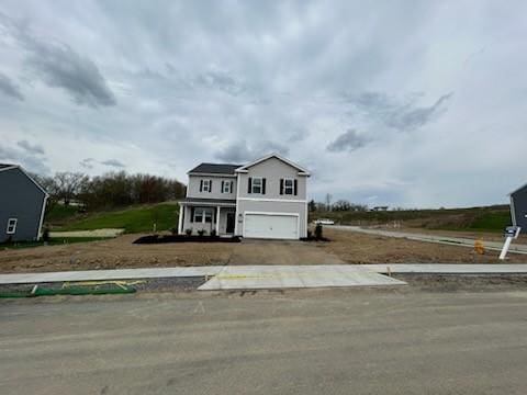 traditional-style home featuring an attached garage and aphalt driveway
