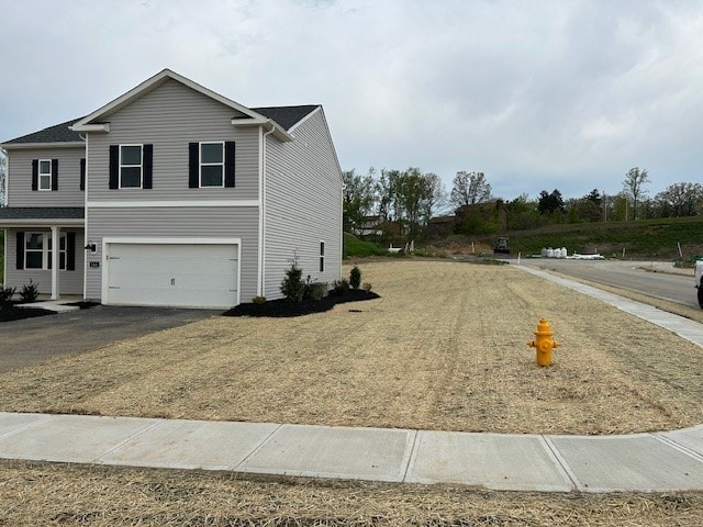 view of home's exterior featuring a garage and aphalt driveway