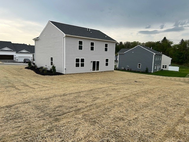 back of house featuring a yard