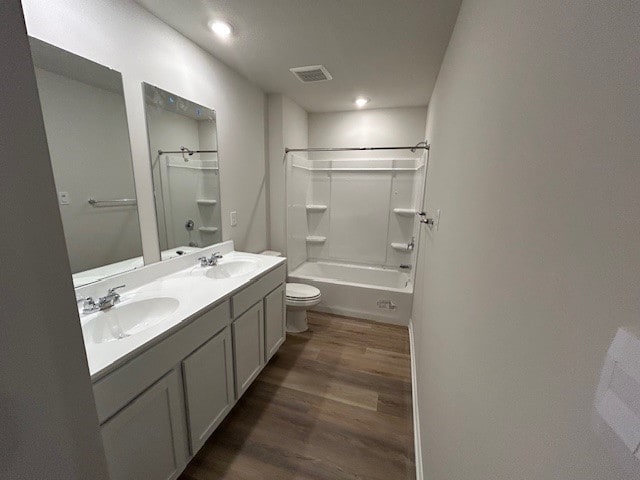 bathroom featuring a sink, wood finished floors, and visible vents