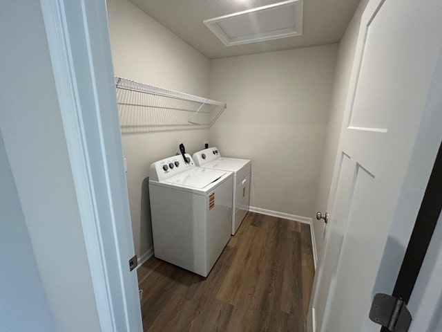 laundry area with laundry area, baseboards, attic access, washer and clothes dryer, and dark wood finished floors