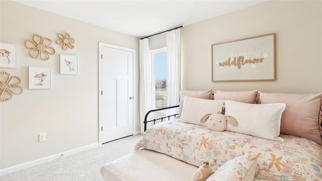 bedroom with carpet floors and baseboards