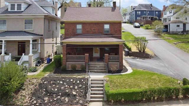 view of front of house featuring a residential view, brick siding, a porch, stairway, and a chimney