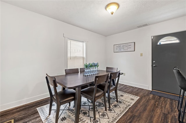 1629 Davidson St, Aliquippa, PA 15001 - dining area with dark wood-style flooring, baseboards, visible vents, and a textured ceiling
