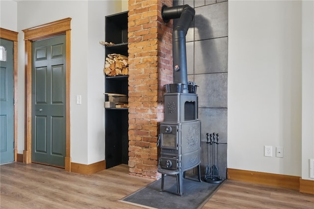 2715 Mission St, South Side, PA 15203 - interior details featuring baseboards, visible vents, wood finished floors, and a wood stove