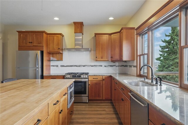 2715 Mission St, South Side, PA 15203 - kitchen featuring wall chimney range hood, a sink, dark wood finished floors, stainless steel appliances, and butcher block counters