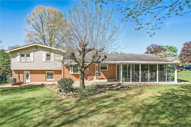 3640 Ridgewood Dr, Hermitage, PA 16148 - rear view of house with a yard, brick siding, a patio, and a sunroom