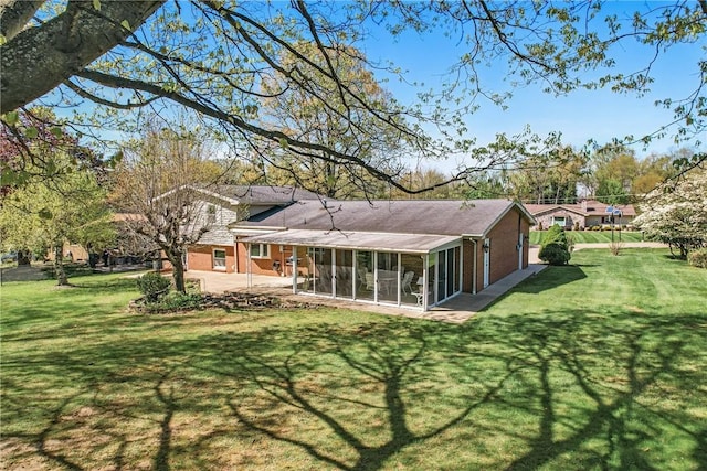 3640 Ridgewood Dr, Hermitage, PA 16148 - rear view of property with a yard, brick siding, a patio area, and a sunroom
