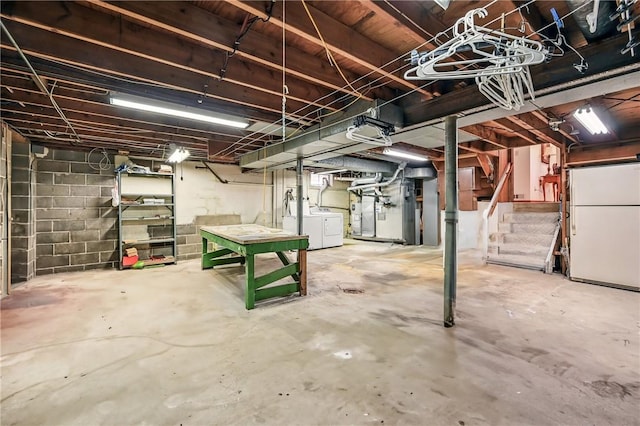 3640 Ridgewood Dr, Hermitage, PA 16148 - unfinished basement featuring washer and clothes dryer, concrete block wall, freestanding refrigerator, and stairway