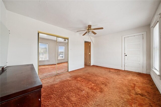 interior space featuring a healthy amount of sunlight, carpet floors, and ceiling fan