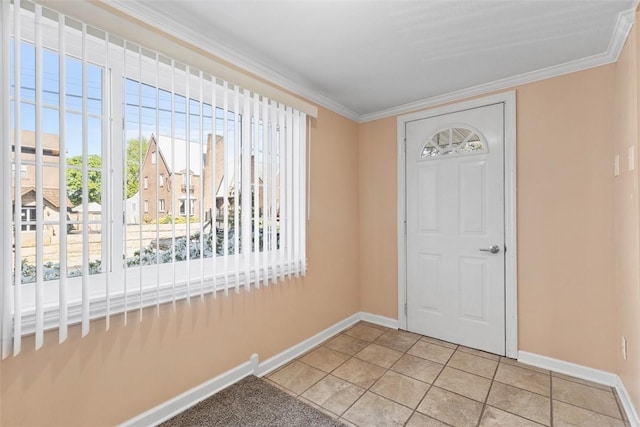 foyer featuring baseboards and ornamental molding