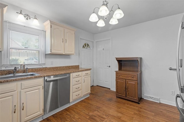 kitchen with visible vents, stainless steel dishwasher, light wood-type flooring, a sink, and a chandelier