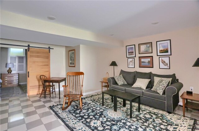 living room featuring tile patterned floors and a barn door