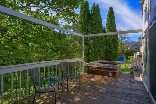 wooden terrace featuring a covered hot tub