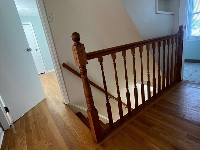 stairs featuring baseboards and wood finished floors