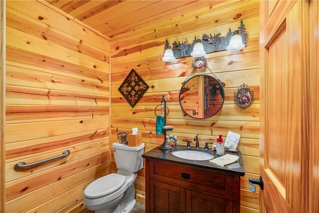 bathroom with wooden ceiling, vanity, wood walls, and toilet