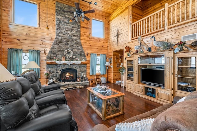 living room with visible vents, wood walls, high vaulted ceiling, wooden ceiling, and a ceiling fan