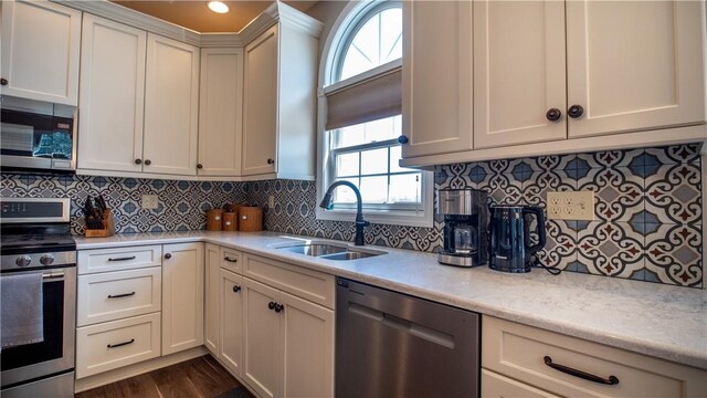 107 Skyview Dr, Buffalo Twp But, PA 16055 - kitchen featuring light stone countertops, a sink, stainless steel appliances, decorative backsplash, and dark wood-style floors