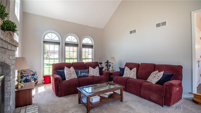 107 Skyview Dr, Buffalo Twp But, PA 16055 - living room featuring high vaulted ceiling, carpet flooring, a stone fireplace, and visible vents