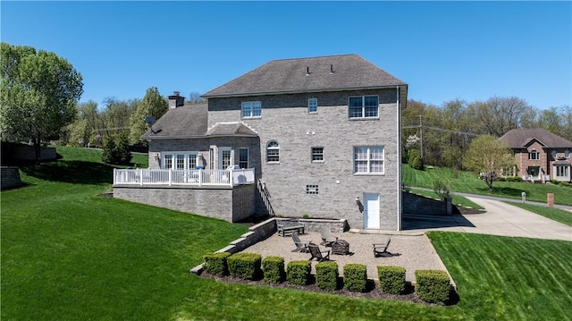 107 Skyview Dr, Buffalo Twp But, PA 16055 - back of house featuring a wooden deck, a patio, a chimney, brick siding, and a lawn