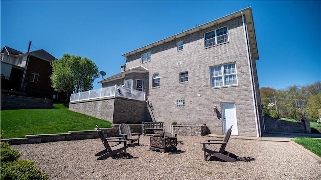 107 Skyview Dr, Buffalo Twp But, PA 16055 - rear view of property with a lawn, a fire pit, and brick siding