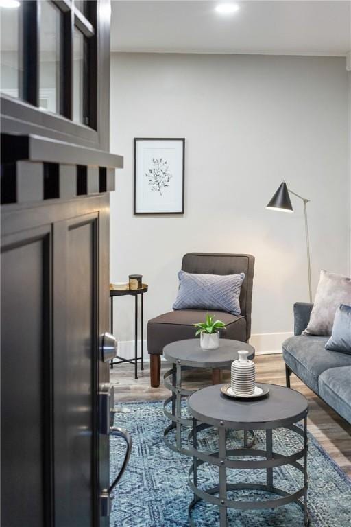 interior space with baseboards and wood finished floors